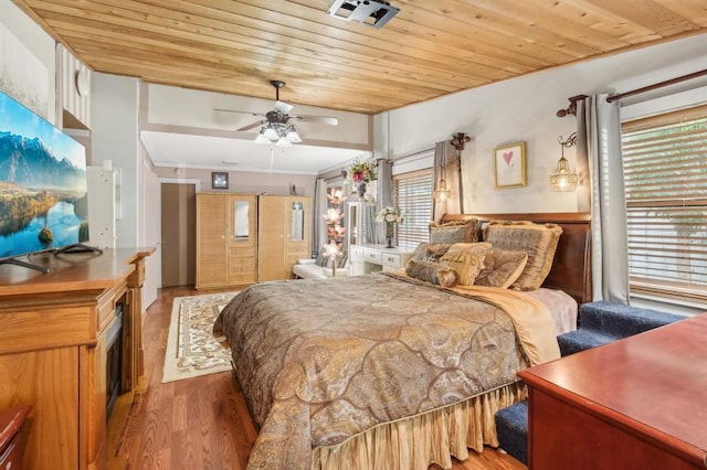 bedroom with ceiling fan, wooden ceiling, and light hardwood / wood-style floors