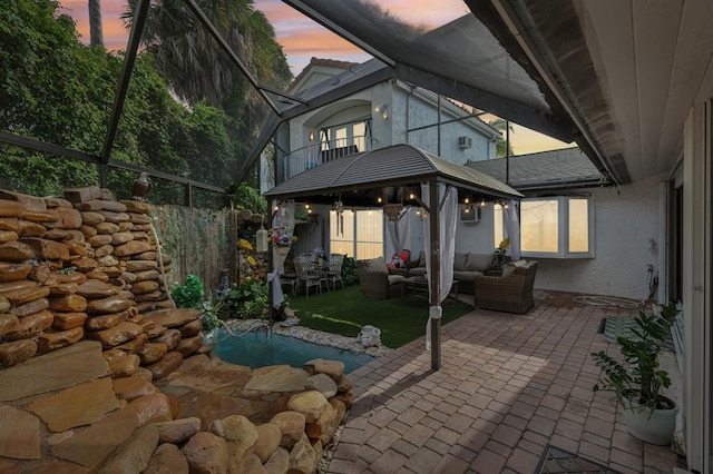 patio terrace at dusk with an outdoor hangout area and a gazebo