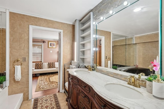 bathroom featuring vanity, tile patterned flooring, and tile walls