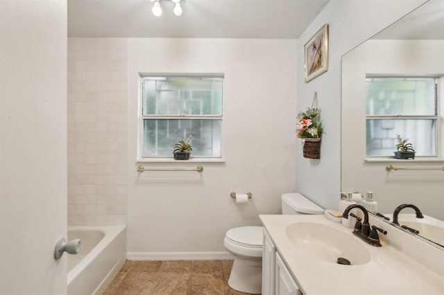 full bathroom featuring vanity, tiled shower / bath combo, toilet, and a wealth of natural light