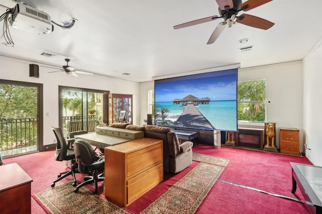 carpeted home office featuring ceiling fan