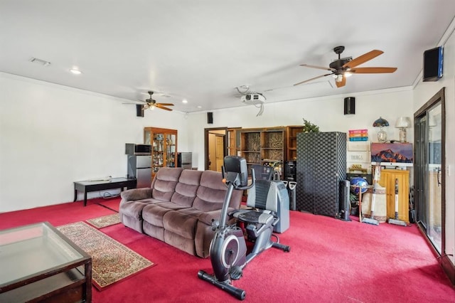 living room with ornamental molding, ceiling fan, and carpet flooring