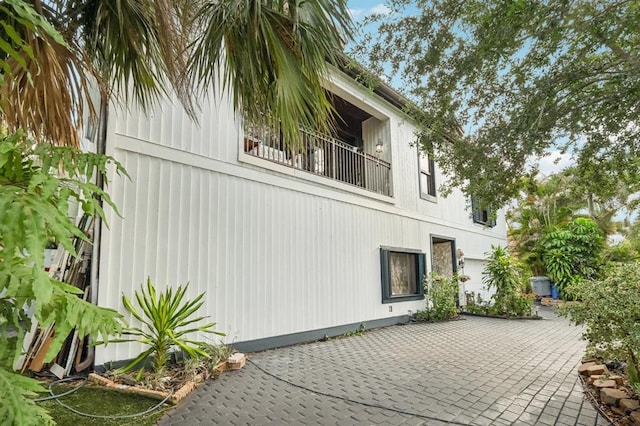 view of side of property with a balcony and a patio area