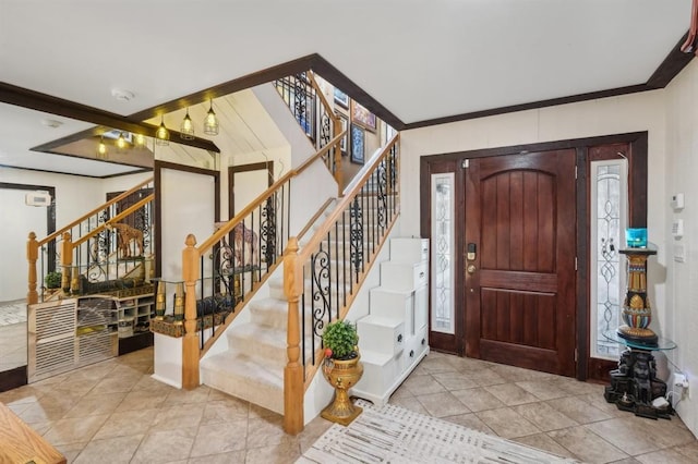 tiled foyer featuring crown molding