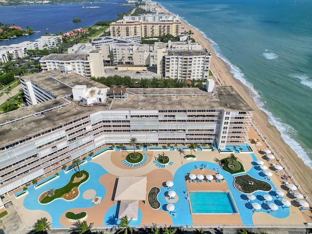 birds eye view of property with a beach view and a water view