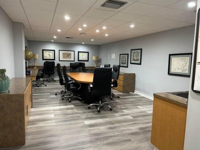 office featuring a drop ceiling and wood-type flooring