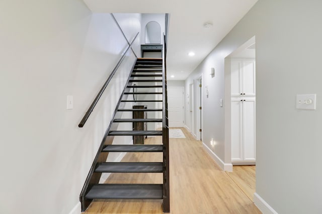 stairs featuring wood-type flooring