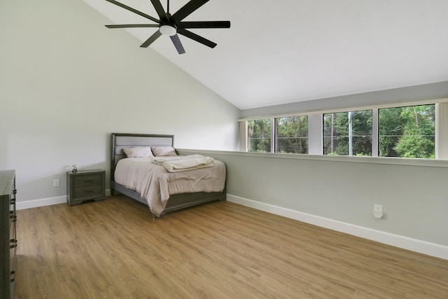 unfurnished bedroom featuring light wood-type flooring, ceiling fan, and lofted ceiling