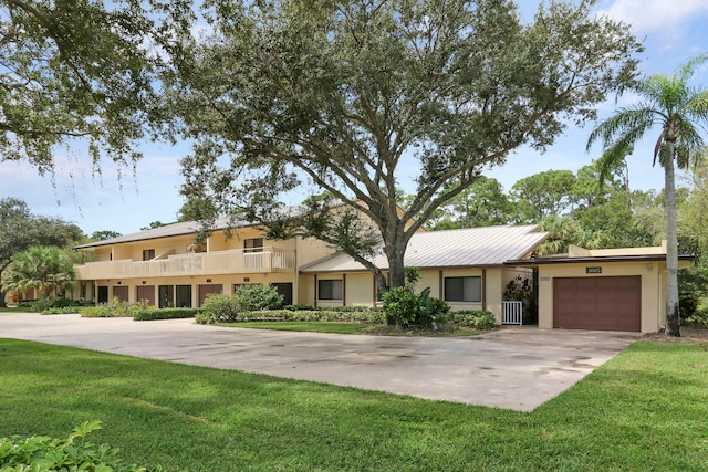 view of front of home with a front yard and a garage