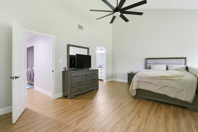 bedroom featuring high vaulted ceiling, washer and dryer, ceiling fan, and light hardwood / wood-style floors