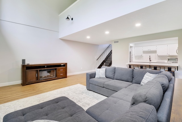 living room with sink and light hardwood / wood-style floors