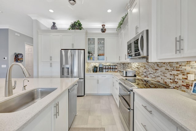 kitchen featuring white cabinets, stainless steel appliances, and sink