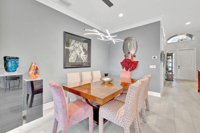 tiled dining space featuring crown molding and a chandelier