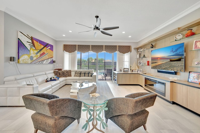 living room featuring ceiling fan and crown molding