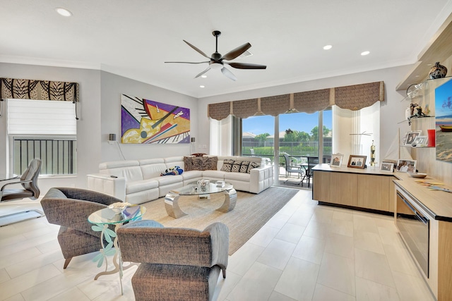 living room featuring crown molding and ceiling fan