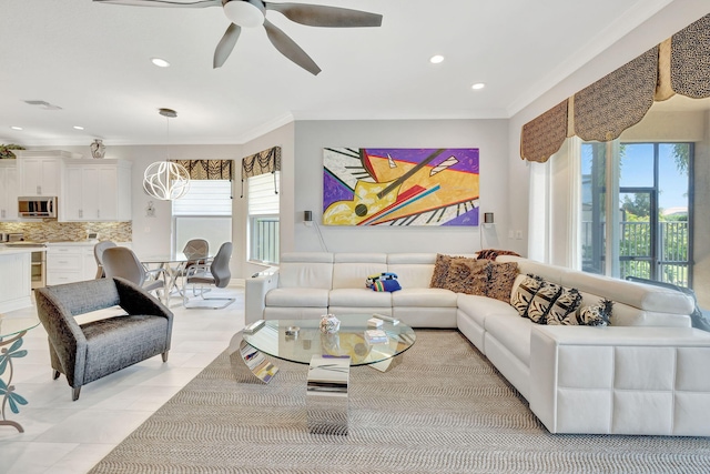 living room featuring light tile patterned floors, crown molding, a wealth of natural light, and ceiling fan