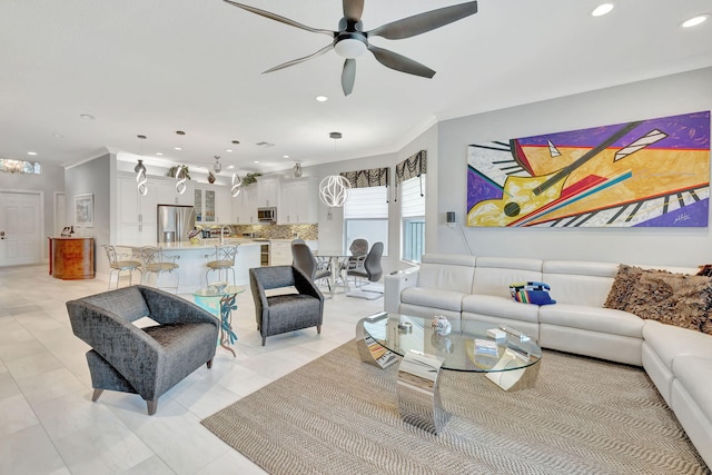 living room featuring ornamental molding, ceiling fan, and light tile patterned floors