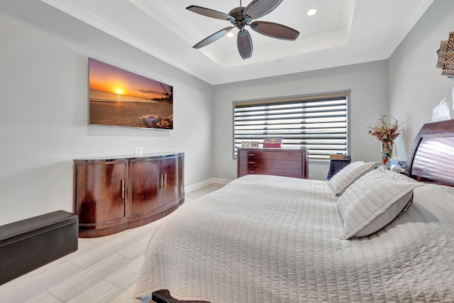 bedroom with a raised ceiling and ceiling fan