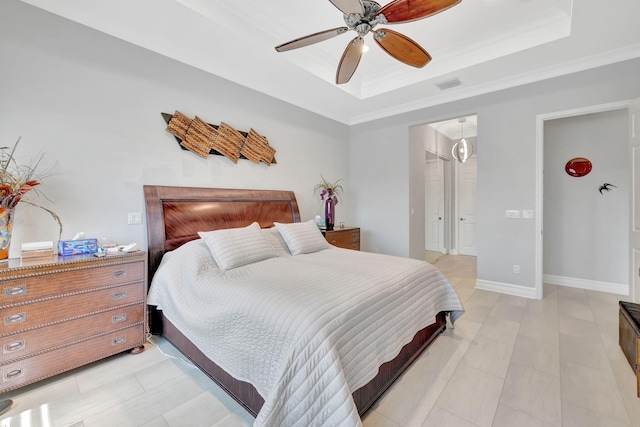 bedroom with ceiling fan, a raised ceiling, and crown molding