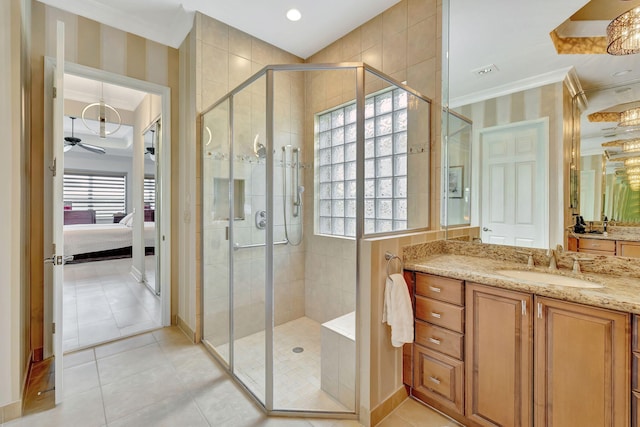 bathroom featuring tile patterned flooring, ceiling fan, crown molding, an enclosed shower, and vanity