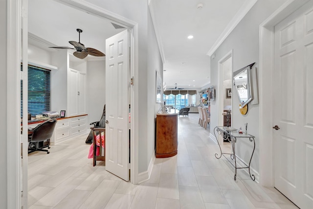 corridor with ornamental molding and light tile patterned floors