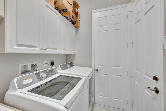 laundry room featuring washer and clothes dryer, cabinets, and light tile patterned flooring