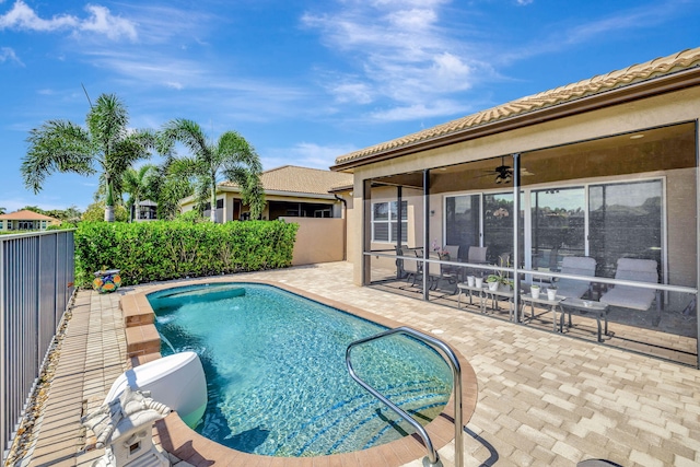 view of swimming pool featuring ceiling fan and a patio area