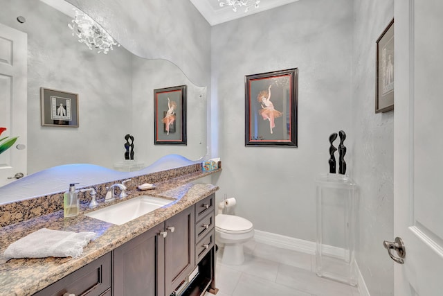 bathroom with ornamental molding, vanity, tile patterned flooring, and toilet