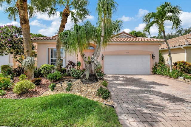 mediterranean / spanish-style house with a garage