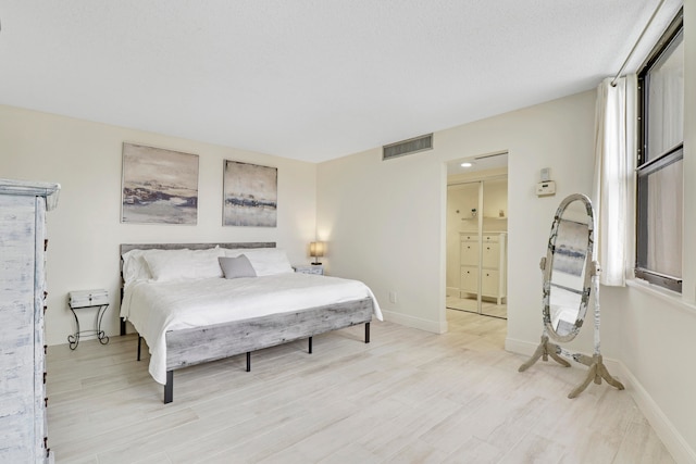 bedroom with light wood-type flooring