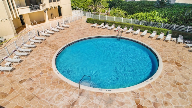 view of swimming pool with a patio