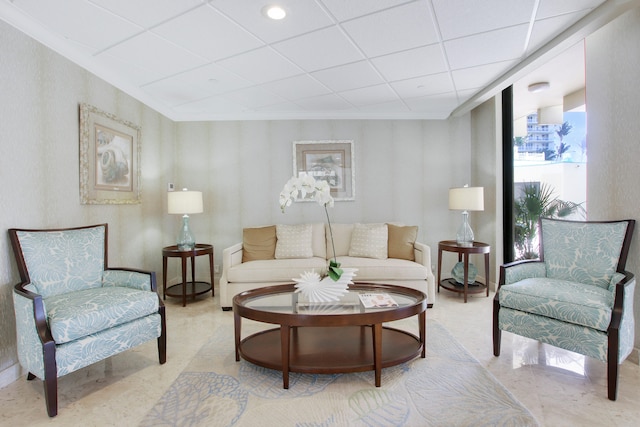 living room featuring a paneled ceiling