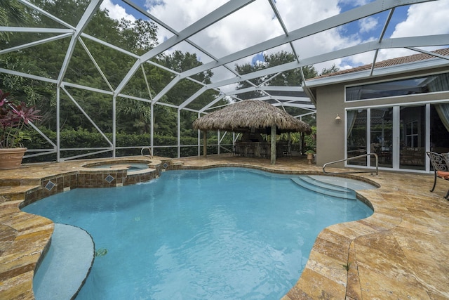 view of pool with a gazebo, a patio area, an in ground hot tub, and glass enclosure