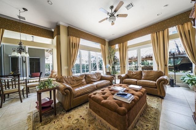 living room featuring ceiling fan with notable chandelier, light tile patterned floors, and ornamental molding