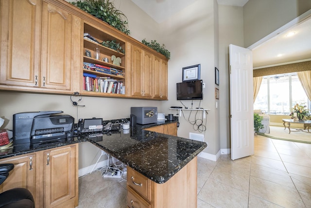 kitchen featuring light tile patterned floors, kitchen peninsula, and dark stone counters