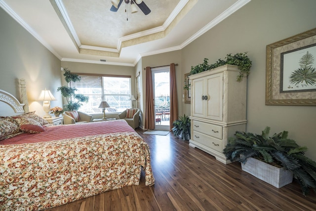 bedroom with access to exterior, ceiling fan, a raised ceiling, dark hardwood / wood-style flooring, and crown molding