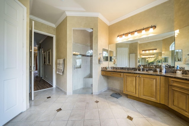 bathroom with tile patterned floors, vanity, a shower with shower door, and ornamental molding