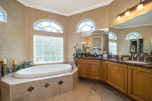 bathroom featuring tile patterned floors, tiled tub, vanity, and ornamental molding