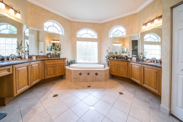 bathroom with tile patterned floors, vanity, a relaxing tiled tub, and ornamental molding