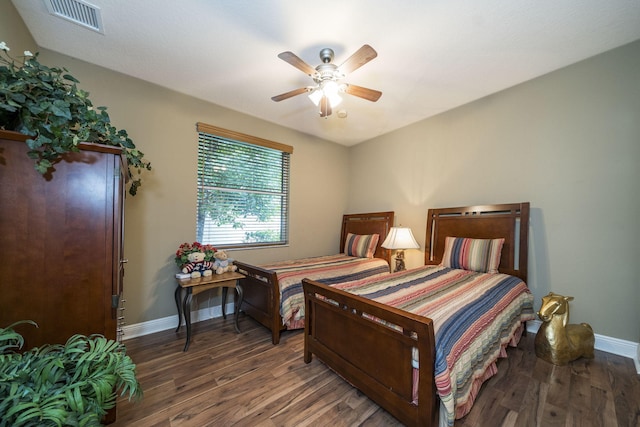 bedroom with ceiling fan and dark wood-type flooring