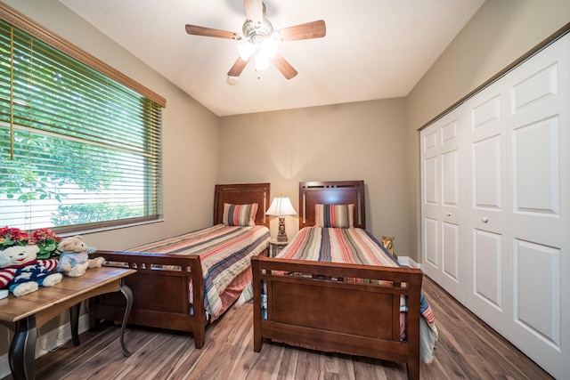 bedroom with ceiling fan, wood-type flooring, and a closet