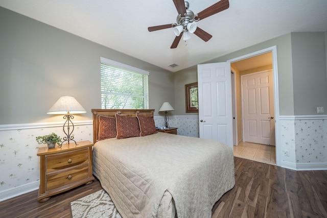 bedroom featuring ceiling fan, hardwood / wood-style floors, and vaulted ceiling