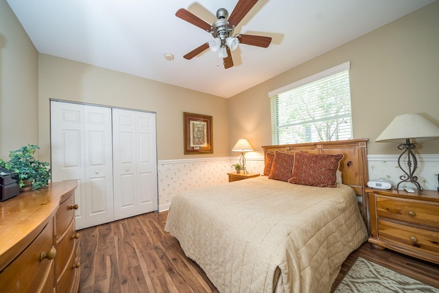 bedroom featuring ceiling fan, a closet, and dark wood-type flooring