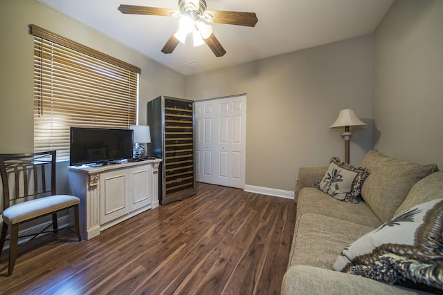 living room with dark hardwood / wood-style floors and ceiling fan