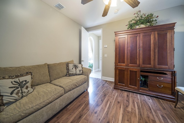 living room featuring dark hardwood / wood-style floors and ceiling fan