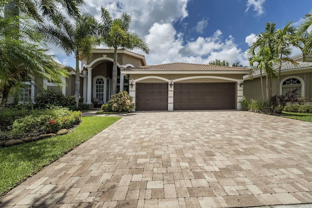 mediterranean / spanish house with a garage