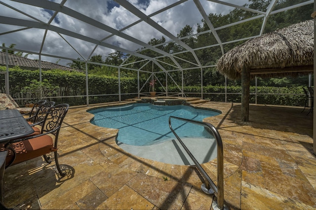 view of pool featuring a lanai, a patio area, and an in ground hot tub