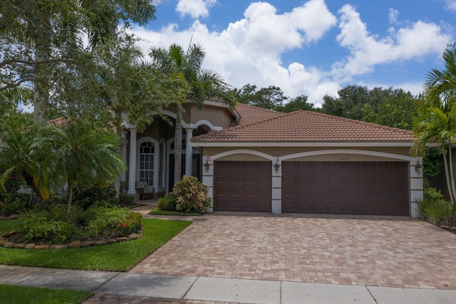 mediterranean / spanish house featuring a garage