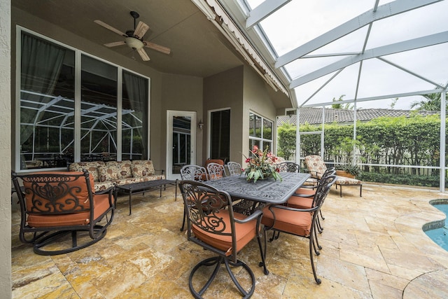 view of patio / terrace featuring outdoor lounge area, ceiling fan, and a lanai