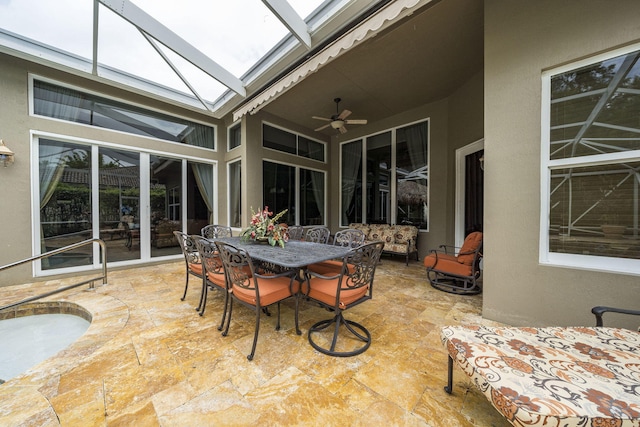 sunroom featuring ceiling fan and plenty of natural light